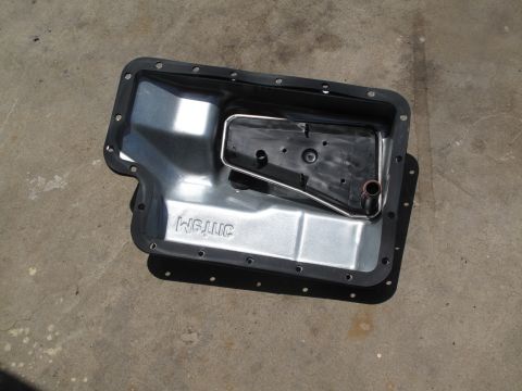 1995 Ford Bronco - Transmission pan and filter assembly, likely for a Ford vehicle, with "WGJNC" stamped on the pan.