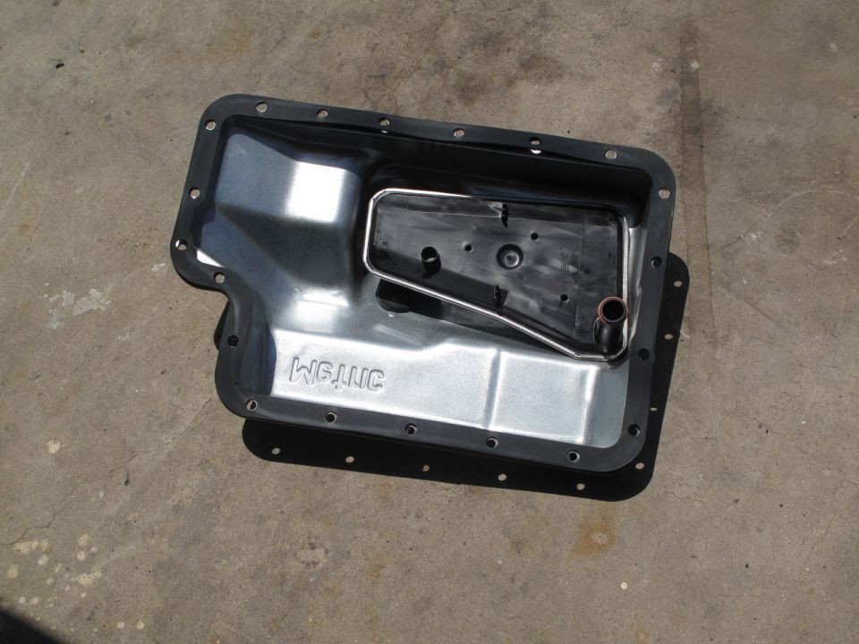 Transmission pan with filter and gasket. Text reads WGJNC
