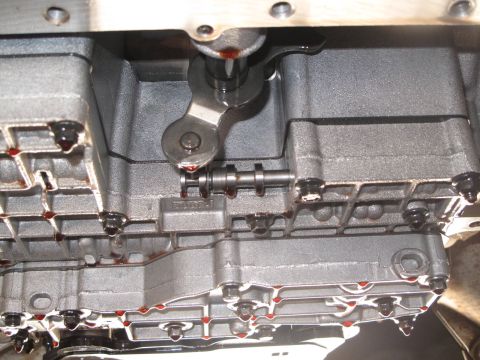 1995 Ford Bronco - Close-up view of internal transmission components, showing the shift lever mechanism and signs of fluid.