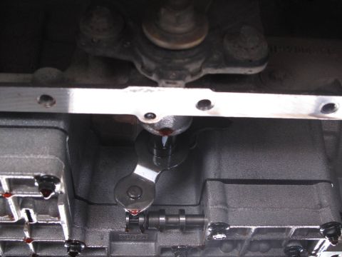 1995 Ford Bronco - Transmission valve body detail with visible fluid drips.