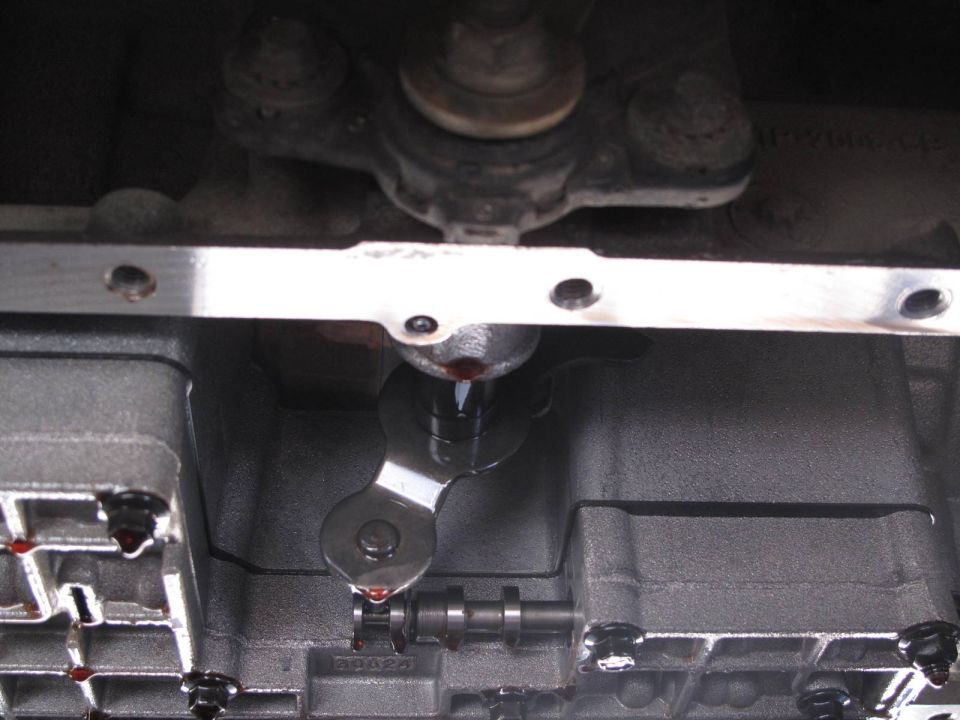 Close-up of a transmission valve body with red fluid dripping
