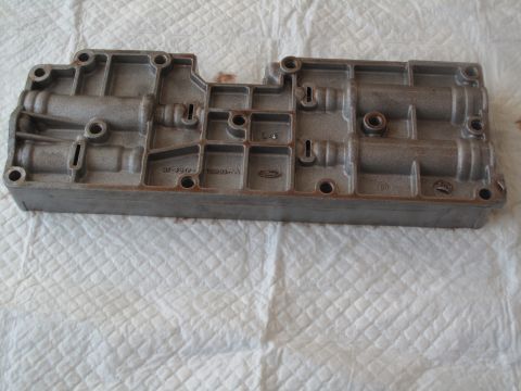 1995 Ford Bronco - A Ford transmission valve body is shown, part numbers and the Ford logo.
