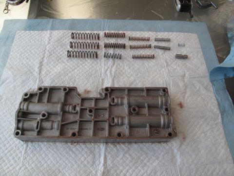 1995 Ford Bronco - Disassembled transmission valve body and springs are laid out for inspection or repair.
