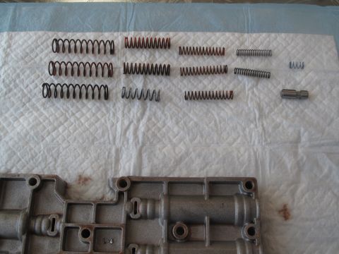 1995 Ford Bronco - Disassembled transmission valve body and springs are laid out for inspection.