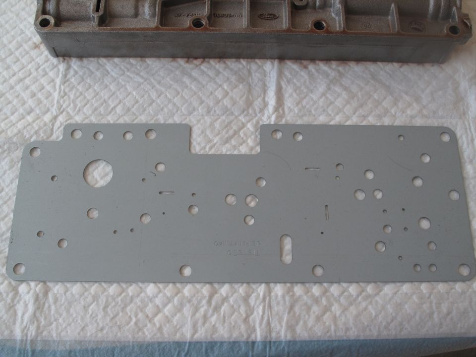 Transmission valve body and gasket with visible Ford logo
