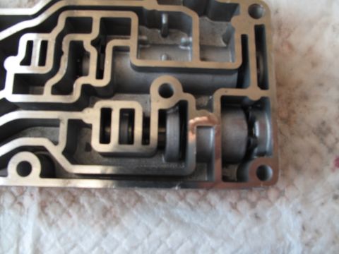 1995 Ford Bronco - Automatic transmission valve body showing intricate internal hydraulic passages and spool valves.