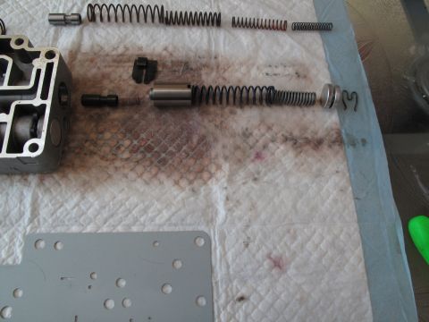 1995 Ford Bronco - Disassembled transmission valve body with various springs and internal components laid out on a shop towel.