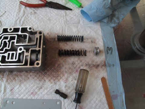 1995 Ford Bronco - Disassembled transmission valve body with various internal components laid out for repair or inspection.