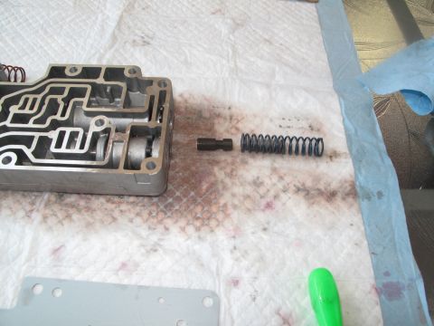 1995 Ford Bronco - Transmission valve body and components disassembled for service.