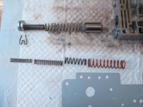1995 Ford Bronco - Disassembled transmission valve body components are laid out for inspection or repair.