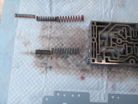 1995 Ford Bronco - Transmission valve body and assorted springs are shown disassembled on a paper towel, likely for repair or upgrade.