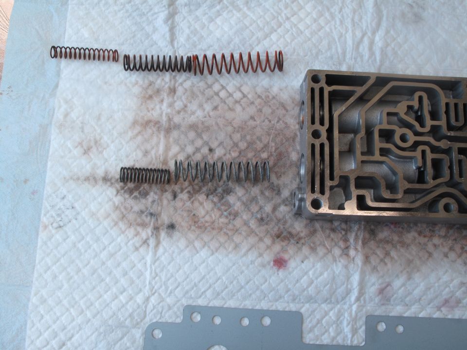 Transmission valve body with four springs laid out on a paper towel