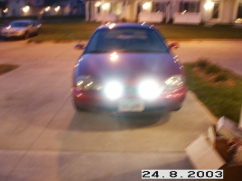 1998 Mercury Sable - A red sedan is parked in a driveway at twilight, with another car in the background.