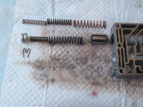 1995 Ford Bronco - Disassembled transmission valve body components including springs and plungers laid out on a paper towel.