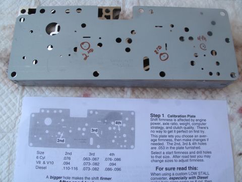 1995 Ford Bronco - Calibration plate for transmission shift firmness, with accompanying instructions and a chart of hole sizes for different engine types.