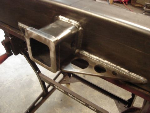 1989 Ford Bronco - Close-up view of a custom-fabricated rear bumper with a welded hitch receiver.