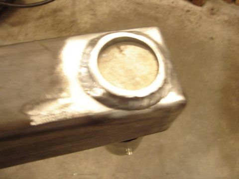 1989 Ford Bronco - Close-up view of a fabricated metal component, likely a custom part, showing a circular recess and weld seams.