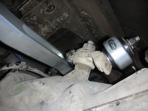 2004 Ford Crown Victoria - Underside view of a vehicle's rear suspension, focusing on an aftermarket adjustable control arm installation.