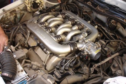 1990 Ford Taurus - The engine's intake manifold and associated wiring are visible in this close-up view.