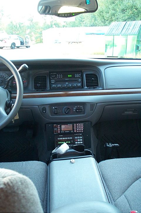 2001 Ford Crown Victoria - Dashboard and center console of a 2001 Ford Crown Victoria, equipped with police radio equipment.