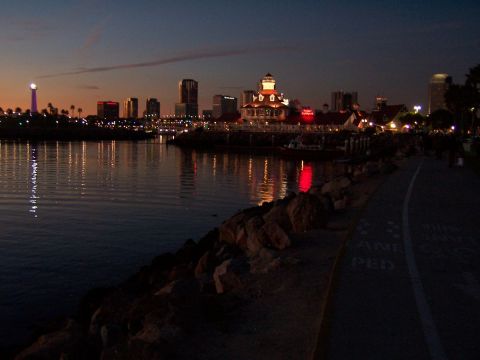 1990 Ford Bronco - The lights of a city reflect on the water as dusk settles over the skyline.