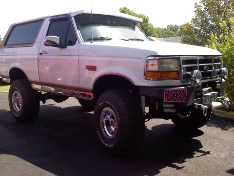 1996 Ford Bronco - This lifted 1996 Ford Bronco features a custom front bumper with auxiliary lights and a prominent decal.