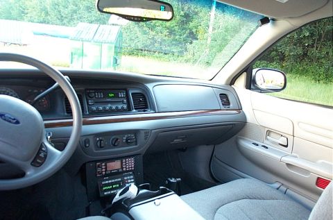 2001 Ford Crown Victoria - The interior of a Ford Crown Victoria is shown, a dashboard with a radio and climate controls.