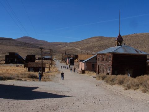 1990 Ford Bronco - View down the main street of a deserted town with mountains in the background.