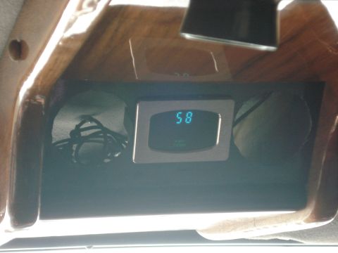 1992 Ford C-350 (Centurion Conversions) - Close-up of a digital gauge and wiring within a vehicle's interior compartment.