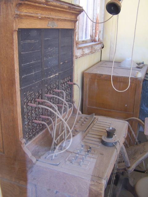 1990 Ford Bronco - An antique telephone switchboard sits dusty in a room, with a vintage handset resting on the console.