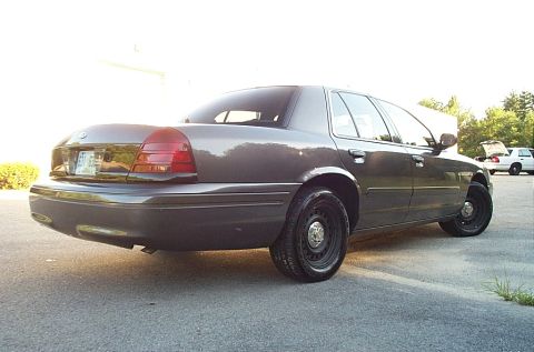 2001 Ford Crown Victoria - This 2001 Ford Crown Victoria is shown from the rear quarter angle, its characteristic body style and steel wheels.