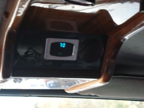 1992 Ford C-350 (Centurion Conversions) - A digital gauge displays a reading of 70 within the cabin of a vehicle, next to a cup holder.