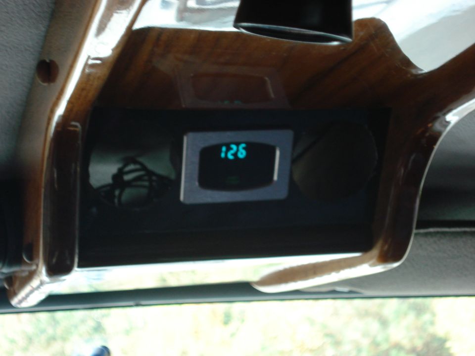 Digital display showing 126 inside a vehicle with wood trim