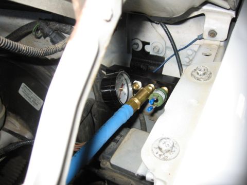 1995 Ford Bronco - manifold up on drivers side by hood hinge.