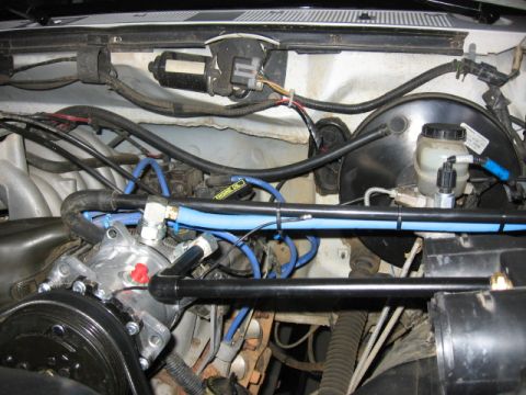 1995 Ford Bronco - Engine bay detail showing an installed onboard air compressor system with blue tubing and various engine components.