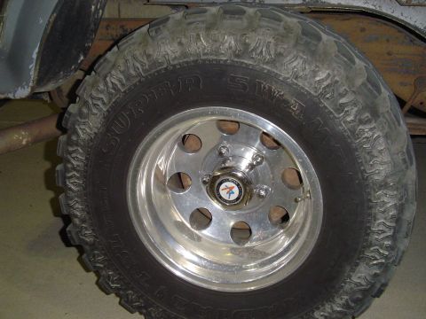 1986 Ford Bronco - A Super Swamper tire is mounted on a chrome wheel, showing off its aggressive tread pattern.