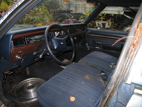 1991 Ford LTD Crown Victoria - Interior view of a 1991 Ford Crown Victoria LTD, blue upholstery and wood-grain dashboard accents.