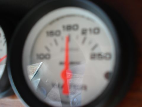 1992 Ford C-350 (Centurion Conversions) - A close-up shot of a vehicle's gauge, showing a red needle indicating a reading on the dial.