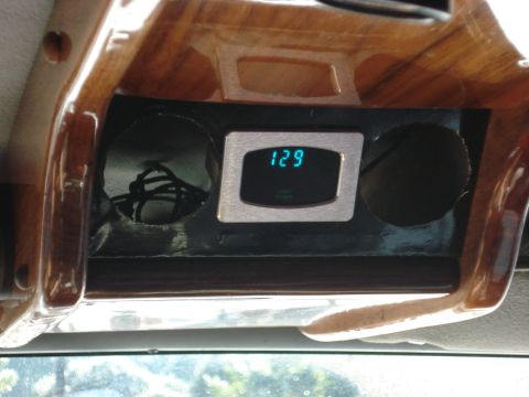 1992 Ford C-350 (Centurion Conversions) - A digital gauge and cup holders are visible in the vehicle's interior, surrounded by wood trim.
