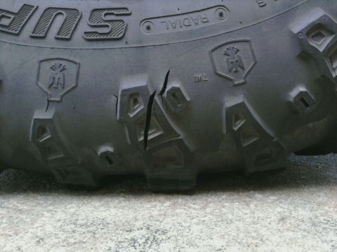 1995 Ford Bronco - A close-up view of a damaged tire shows significant cracking on its sidewall.