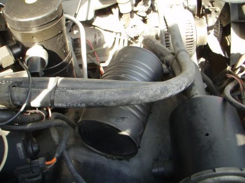 1995 Ford Bronco - Close-up of an engine bay, focusing on the air intake system and hoses.