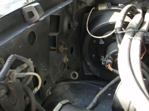 1995 Ford Bronco - Close-up view of engine bay components including wiring and a blower motor housing.