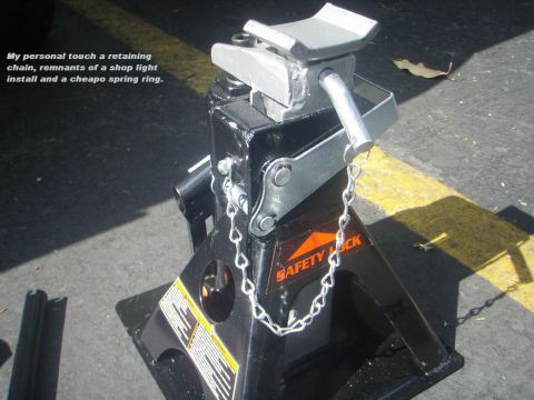 1995 Ford Bronco - A jack stand is shown with a retaining chain and remnants of a shop light install.
