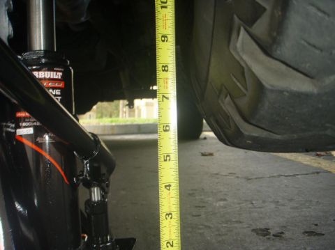1995 Ford Bronco - Measuring the ground clearance of a vehicle with a tape measure and a jack.