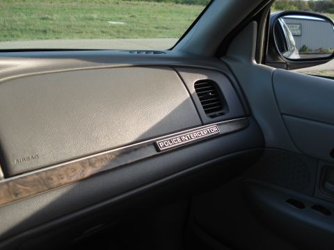 2000 Ford Crown Victoria - Interior view of a 2000 Ford Crown Victoria Police Interceptor, showing the dashboard and door panel.