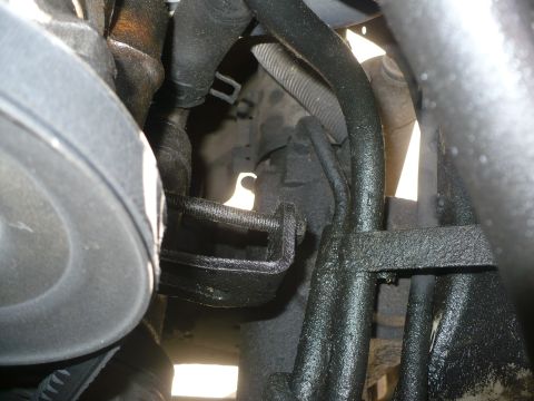 1986 Toyota Land Cruiser - This image shows a close-up view of various engine components, including hoses and mounting brackets.