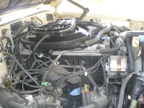 1986 Toyota Land Cruiser - Close-up view of the engine compartment of a 1986 Toyota Land Cruiser, detailing various engine components and wiring.