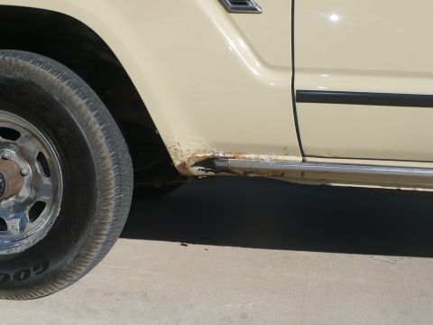 1986 Toyota Land Cruiser - The lower body panel of the vehicle shows significant rust and corrosion damage.