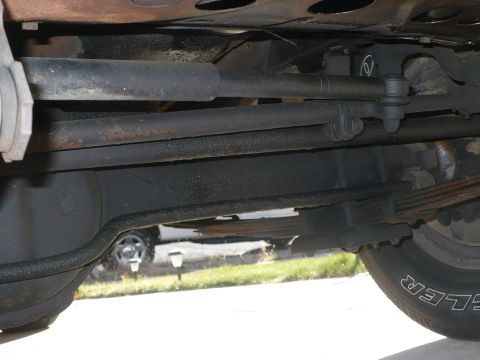 1986 Toyota Land Cruiser - Close-up of the steering and suspension system from underneath a vehicle.