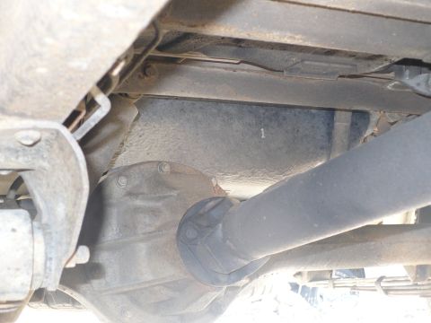 1986 Toyota Land Cruiser - A close-up view of the underside of a vehicle, focusing on the driveshaft and differential assembly. A single digit '1' is visible on the c…